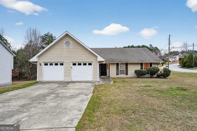 a view of a house with a yard and garage