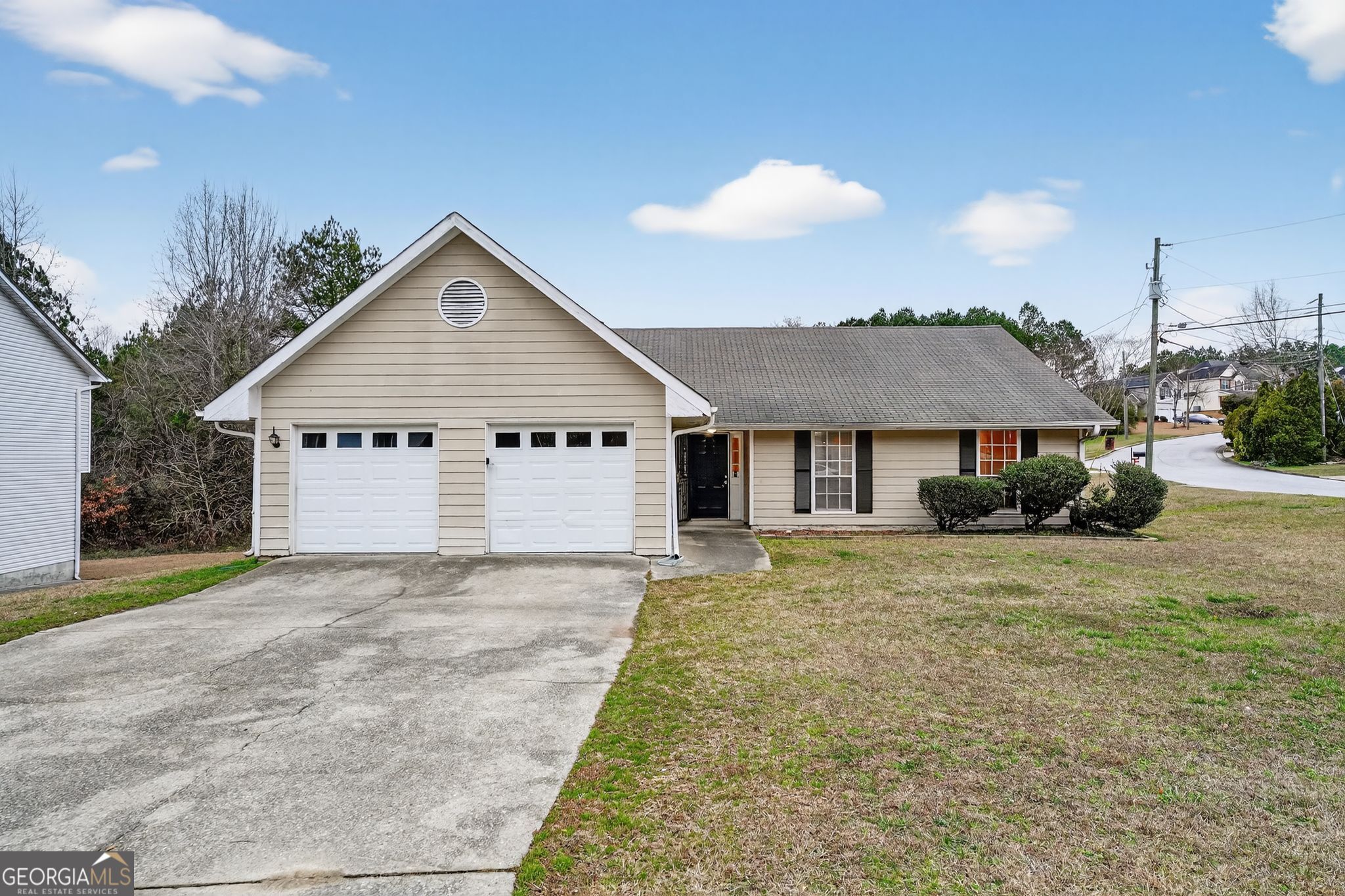 205 Whirlwind Court Atlanta, GA 30349 - Photo 1 of 32 a view of a house with a yard and garage
