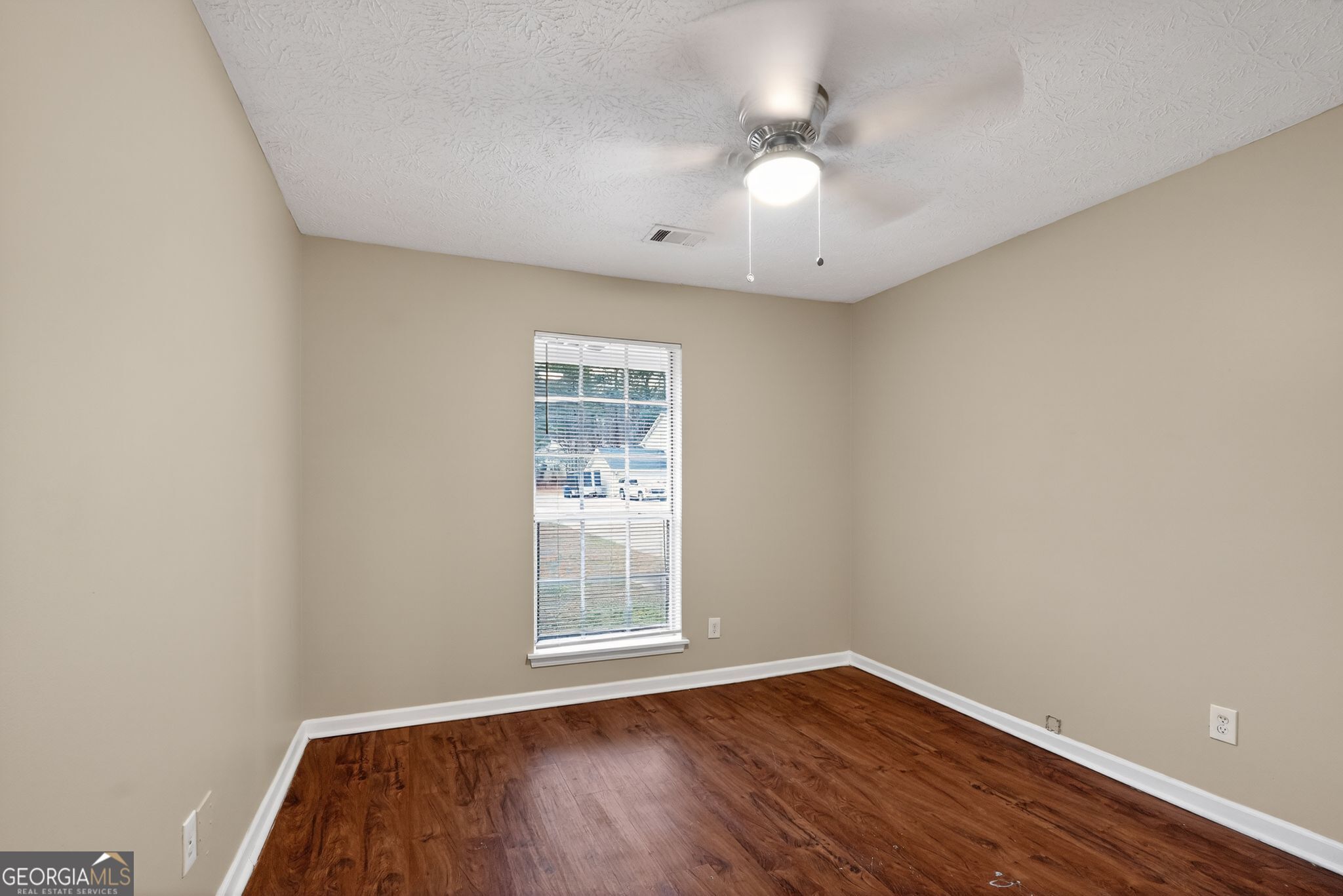 205 Whirlwind Court Atlanta, GA 30349 - Photo 15 of 32 an empty room with wooden floor and windows