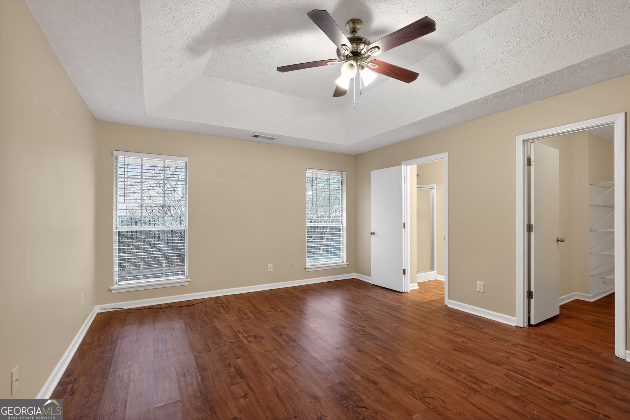 205 Whirlwind Court Atlanta, GA 30349 - Photo 20 of 32 a view of an empty room with wooden floor and a window
