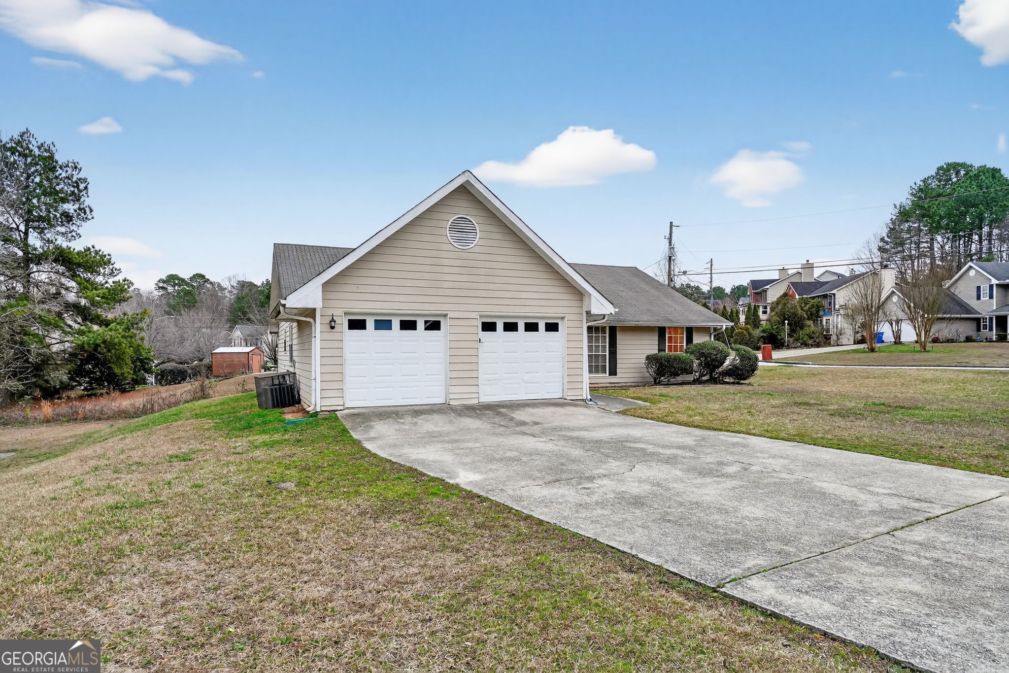 205 Whirlwind Court Atlanta, GA 30349 - Photo 2 of 32 a view of a house with a yard and garage
