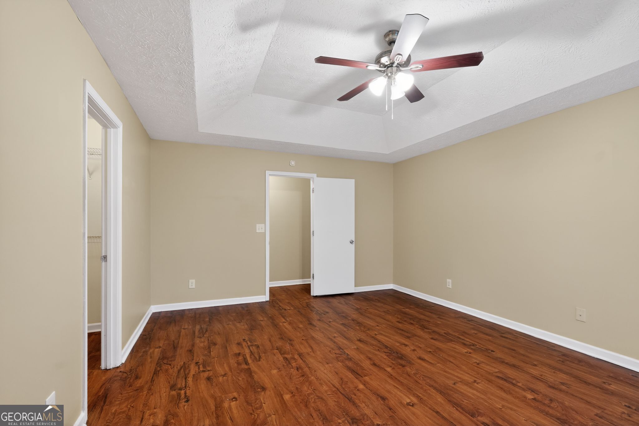 205 Whirlwind Court Atlanta, GA 30349 - Photo 21 of 32 an empty room with wooden floor and ceiling fan