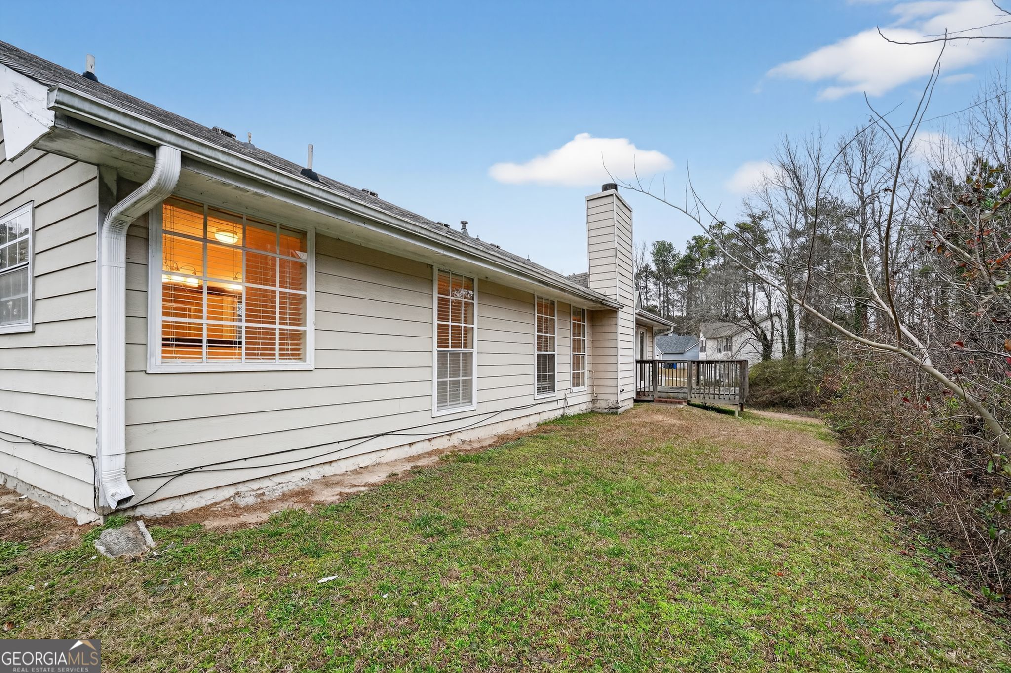 205 Whirlwind Court Atlanta, GA 30349 - Photo 30 of 32 a backyard of a house with plants and outdoor seating