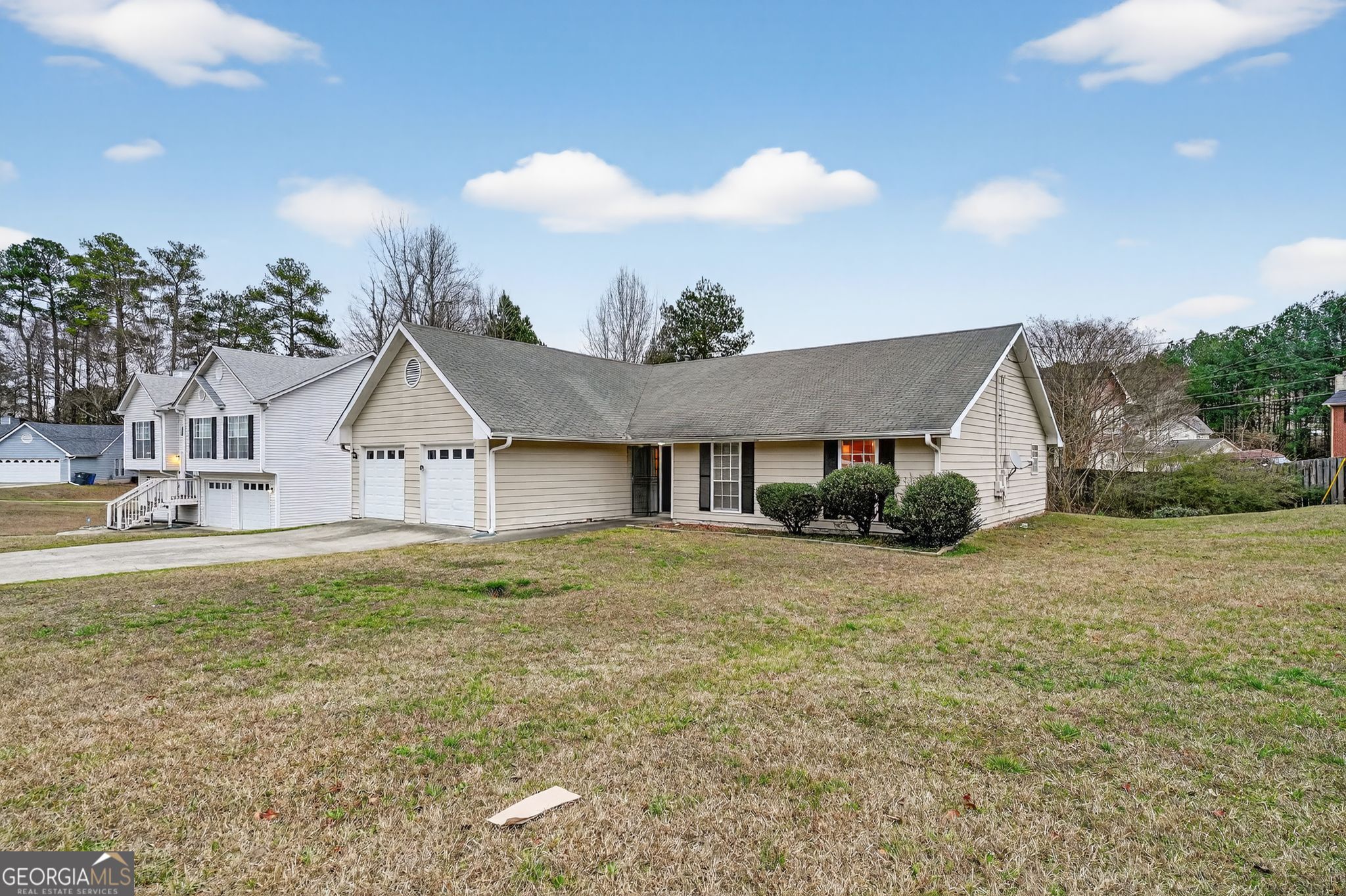 205 Whirlwind Court Atlanta, GA 30349 - Photo 3 of 32 a front view of a house with garden