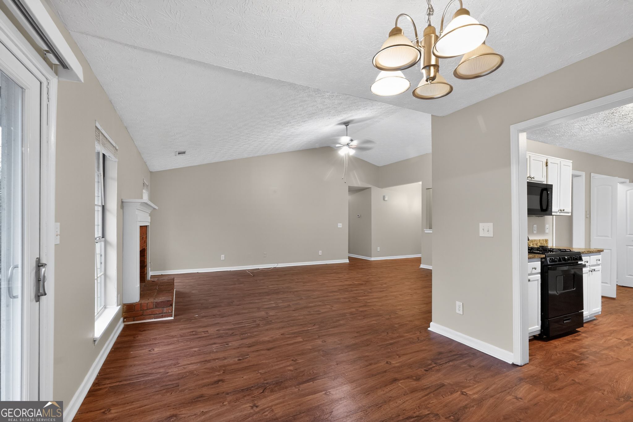 205 Whirlwind Court Atlanta, GA 30349 - Photo 9 of 32 a view of an empty room with wooden floor