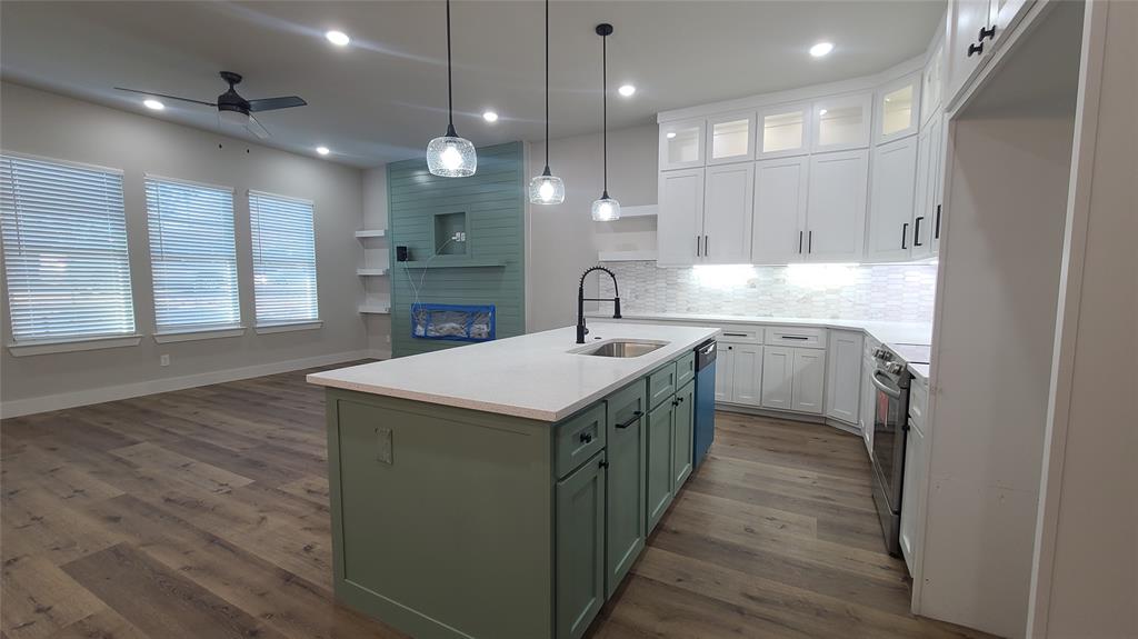 2142 Edd Road Dallas, TX 75253 - Photo 4 of 14 a kitchen with kitchen island a sink stainless steel appliances and cabinets