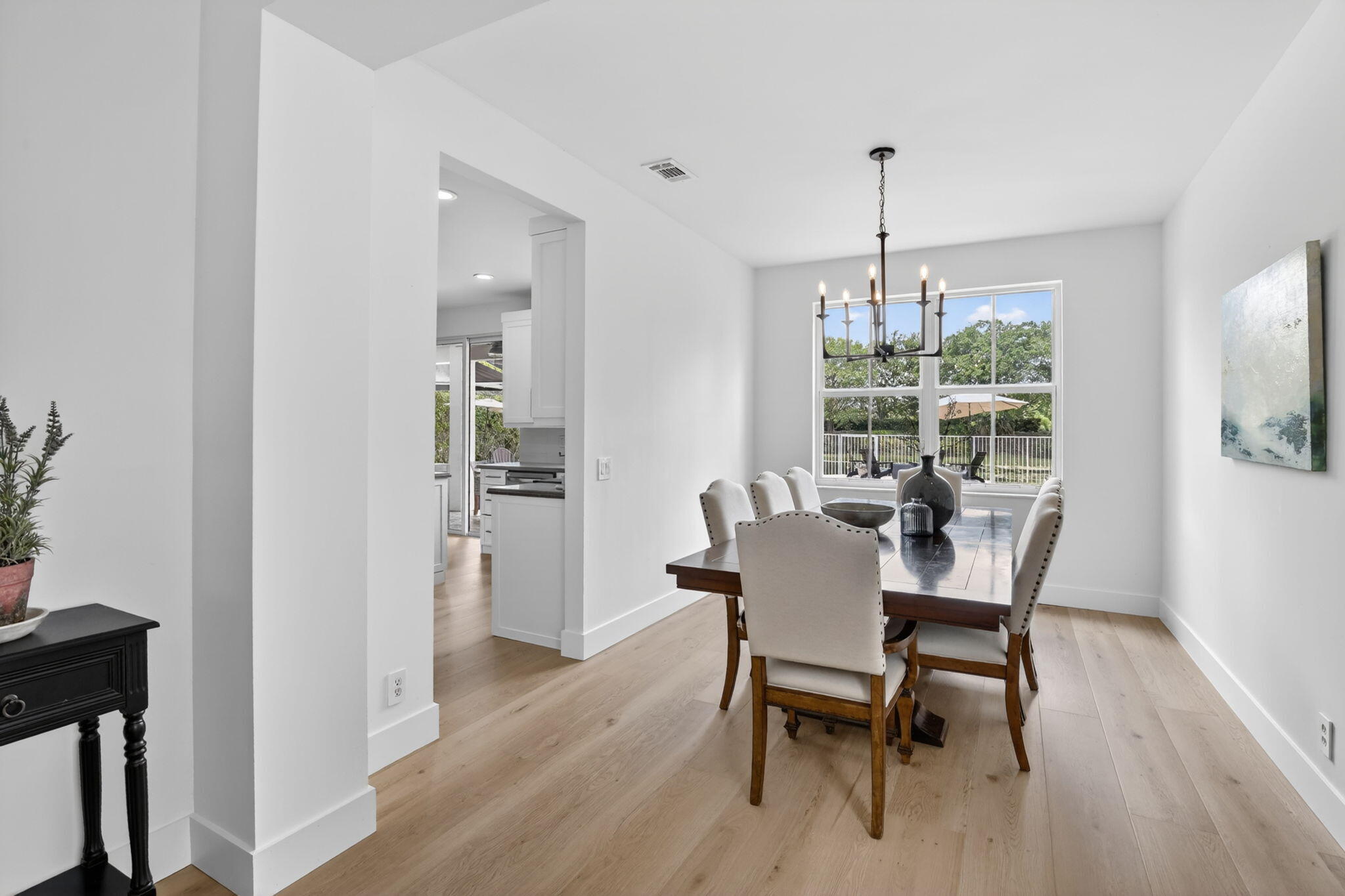 4299 Laurel Ridge Circle Weston, FL 33331 - Photo 22 of 103 a dining room with furniture a chandelier and wooden floor