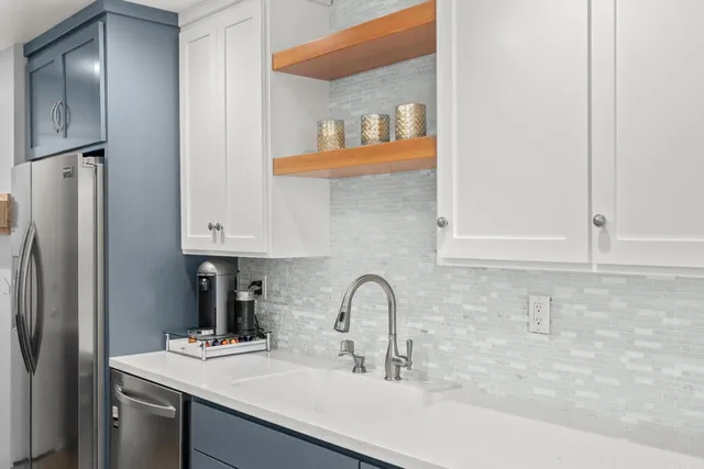 a kitchen with a sink a stove and chairs