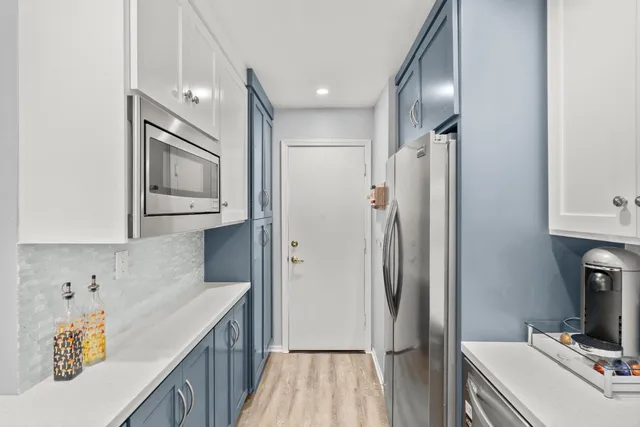 a kitchen with stainless steel appliances kitchen island granite countertop a sink and cabinets