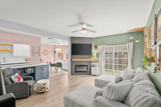 a living room with furniture and wooden floor