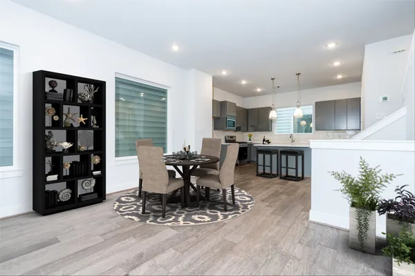 a dining room with furniture and wooden floor