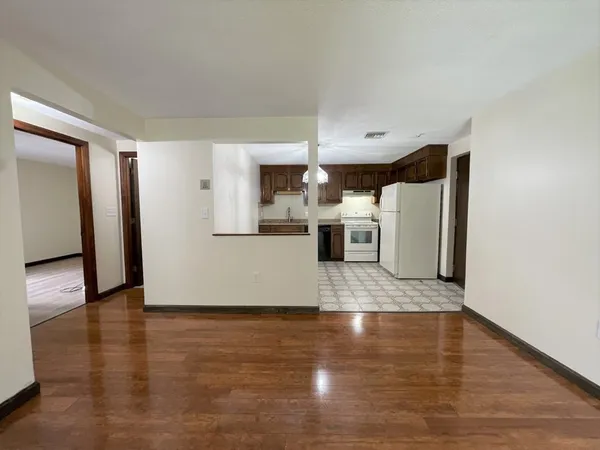 a view of a kitchen with wooden floor