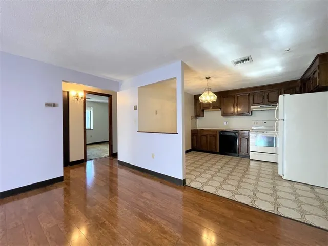 a view of a kitchen with a sink and a refrigerator