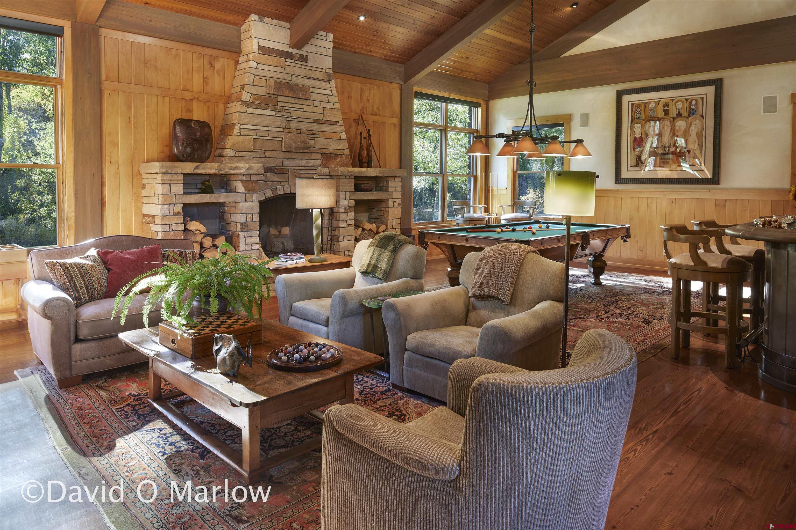 505 Eagle Creek Road Gunnison, CO 81230 - Photo 12 of 45 a living room with furniture a fireplace and a table
