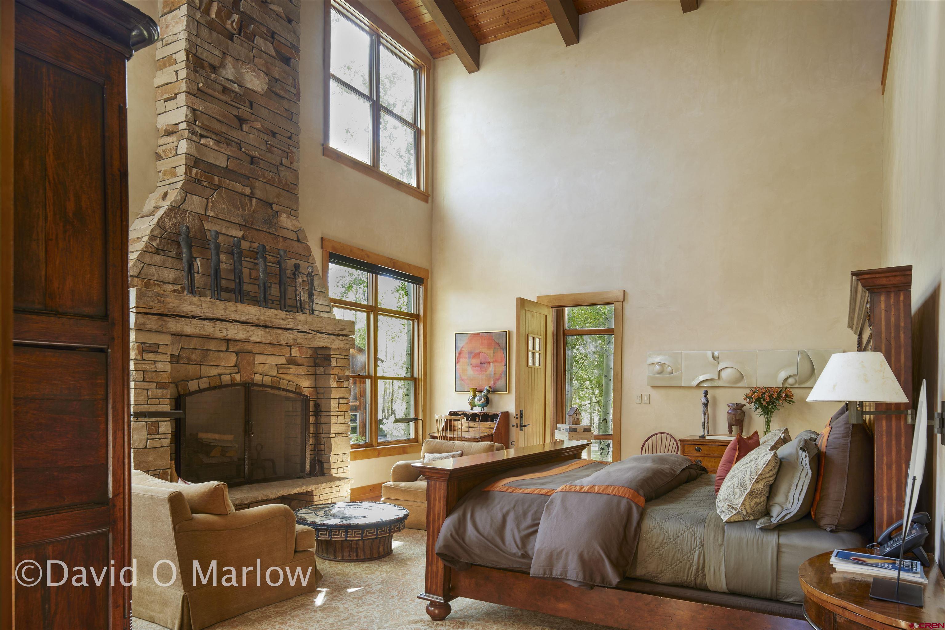 505 Eagle Creek Road Gunnison, CO 81230 - Photo 19 of 45 a living room with furniture a fireplace and a flat screen tv