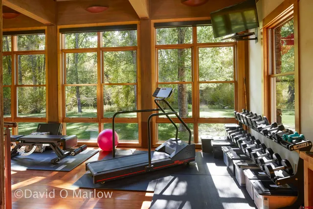 a living room with furniture and floor to ceiling windows
