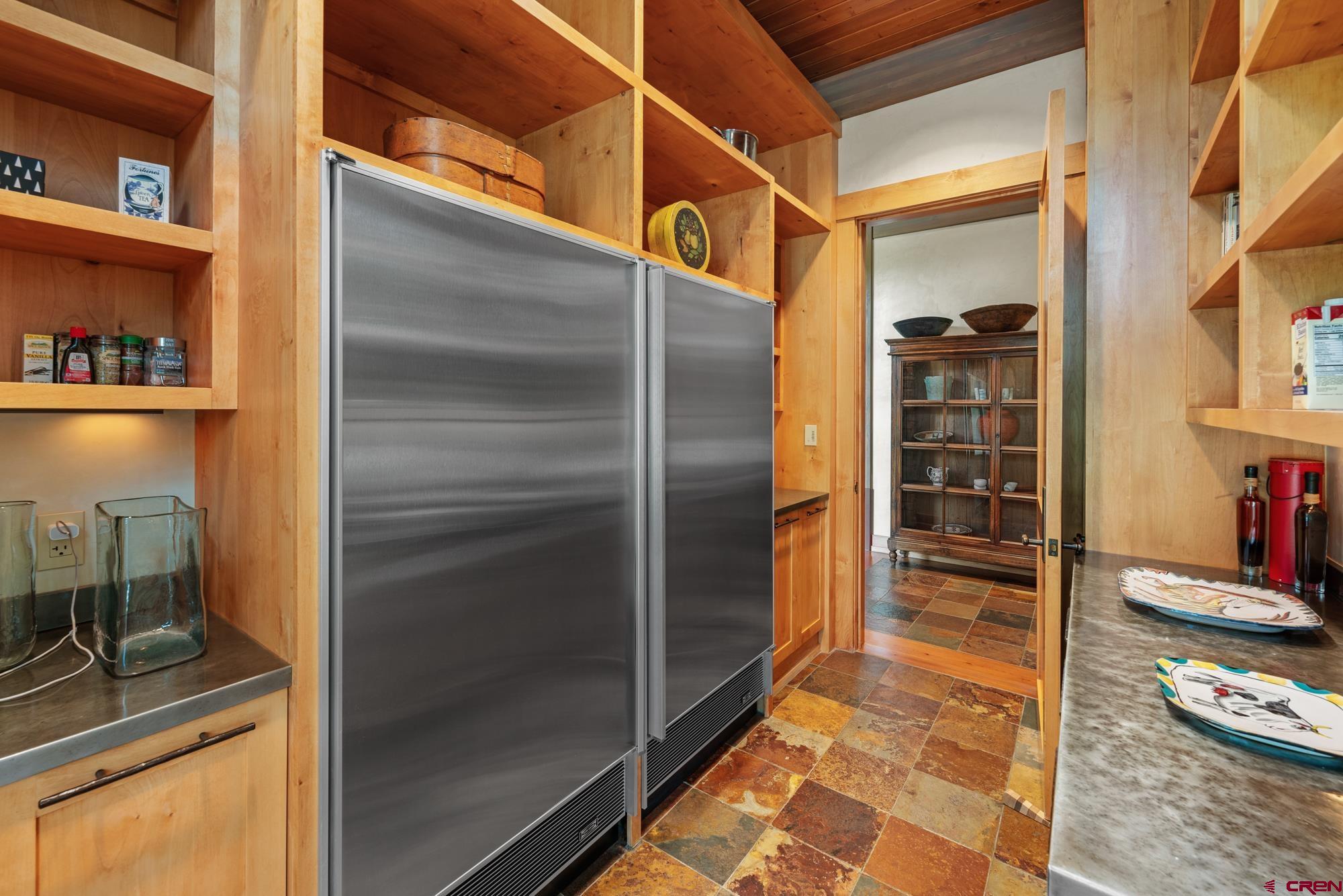 505 Eagle Creek Road Gunnison, CO 81230 - Photo 25 of 45 a kitchen with refrigerator and cabinets