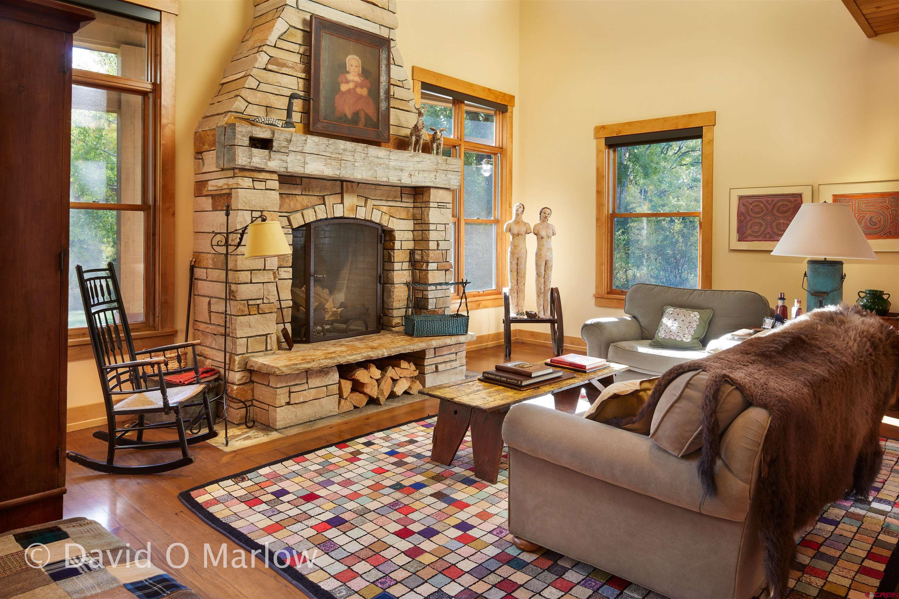 505 Eagle Creek Road Gunnison, CO 81230 - Photo 28 of 45 a living room with furniture a rug and a fireplace