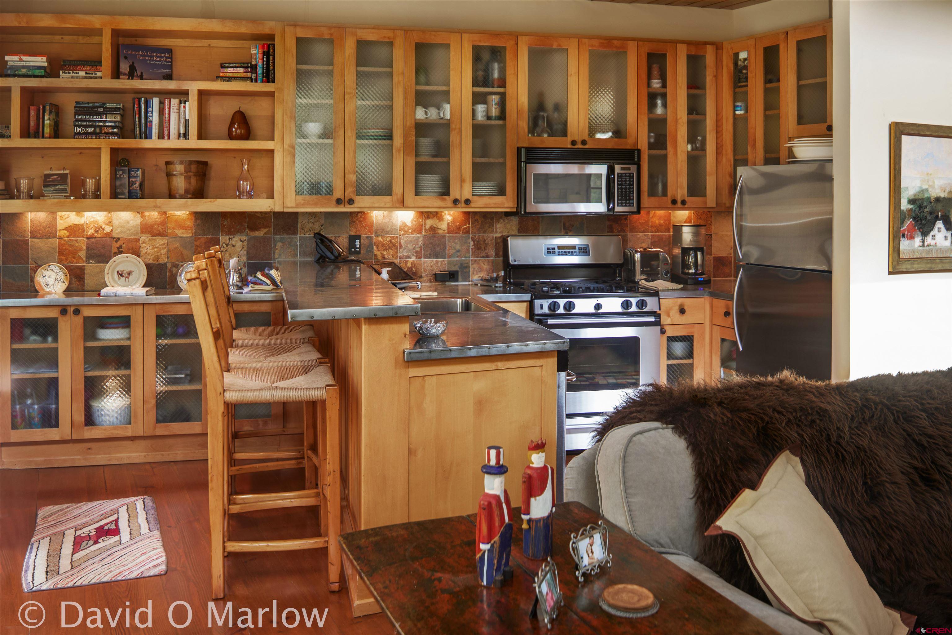 505 Eagle Creek Road Gunnison, CO 81230 - Photo 29 of 45 a kitchen with a stove a refrigerator and a dining table