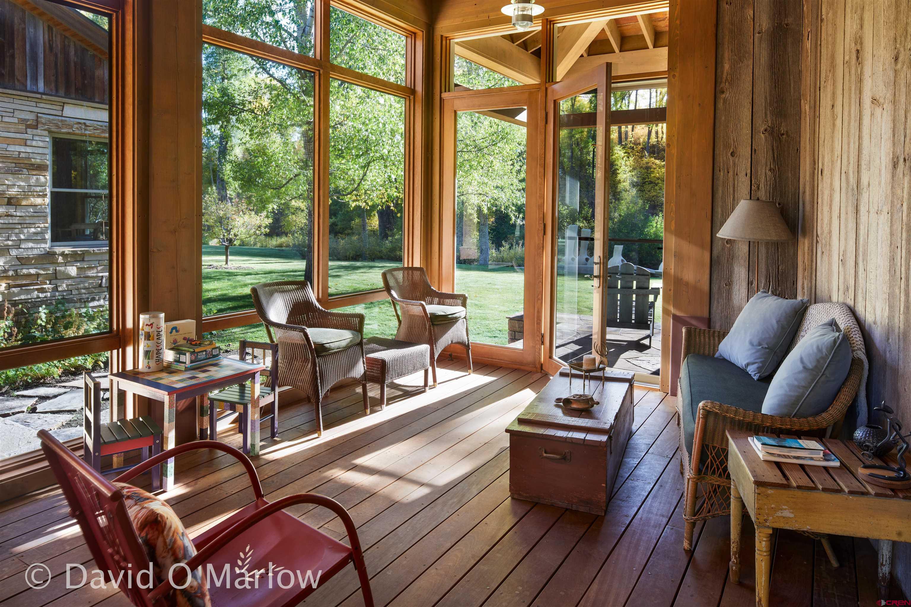 505 Eagle Creek Road Gunnison, CO 81230 - Photo 30 of 45 a living room with furniture and floor to ceiling windows