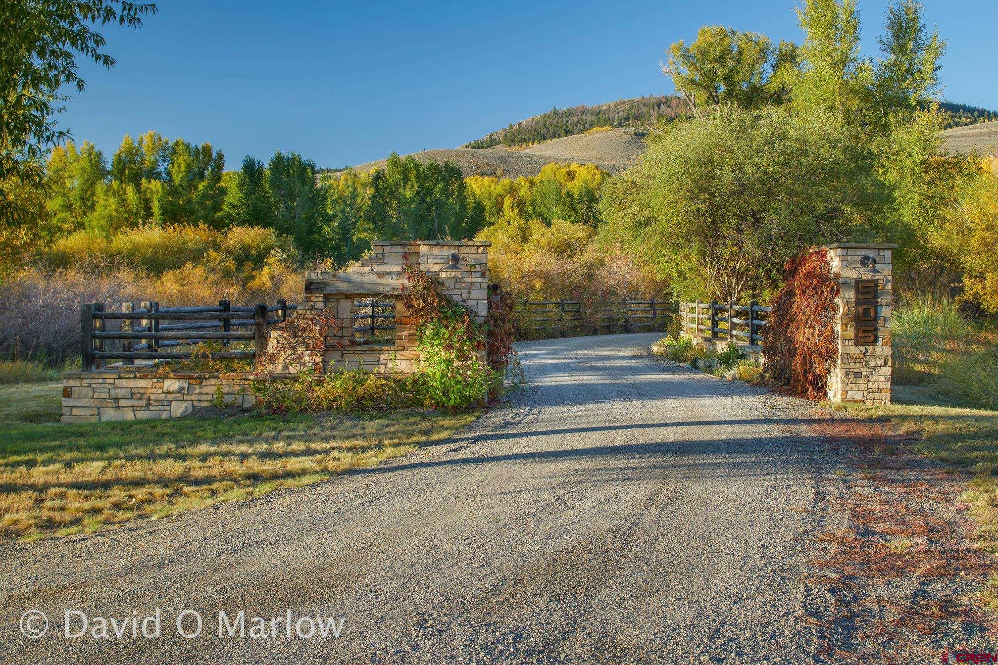 505 Eagle Creek Road Gunnison, CO 81230 - Photo 3 of 45 a view of a house with a yard and large trees