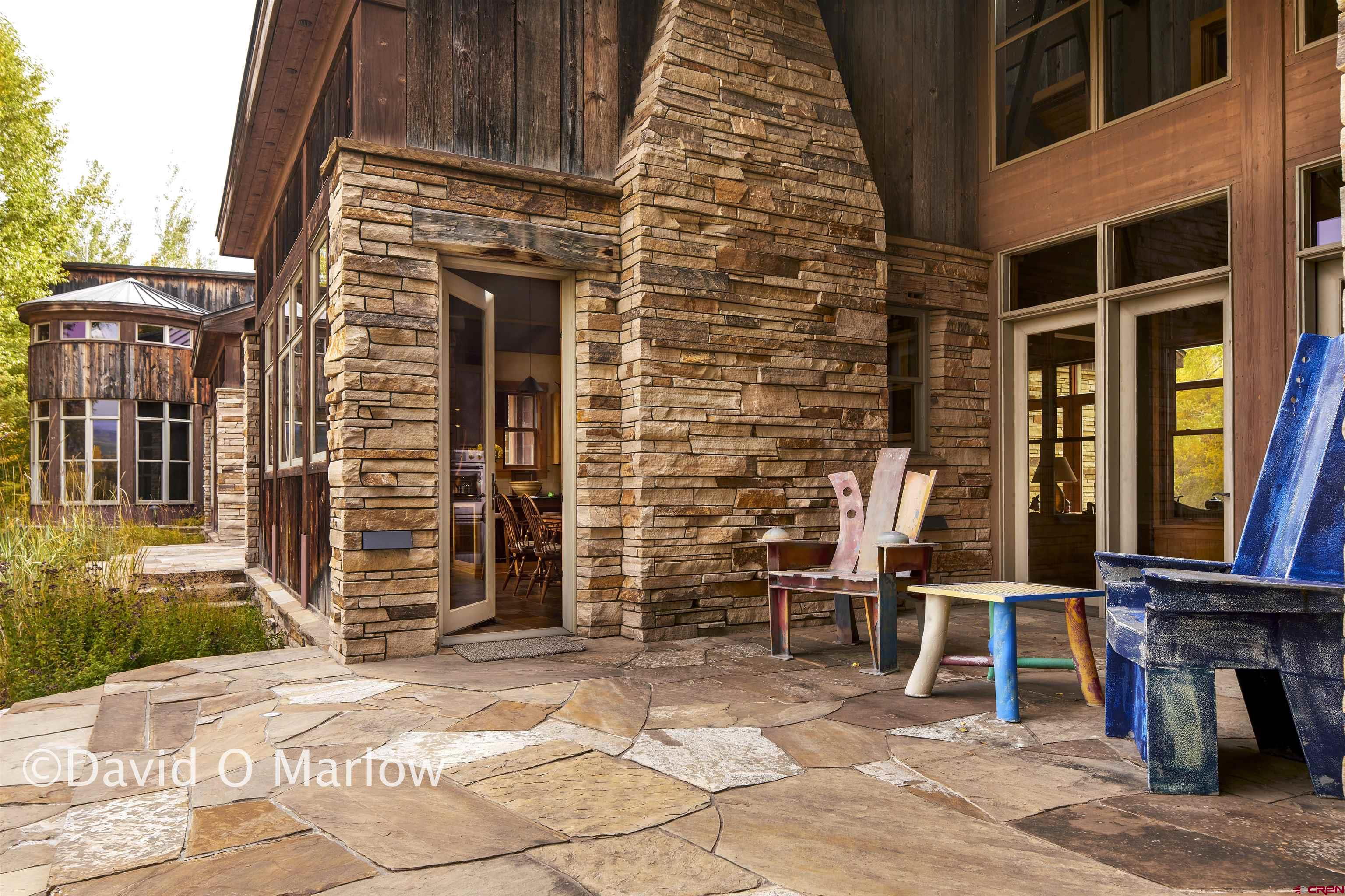 505 Eagle Creek Road Gunnison, CO 81230 - Photo 6 of 45 a brick building with a bench and a window