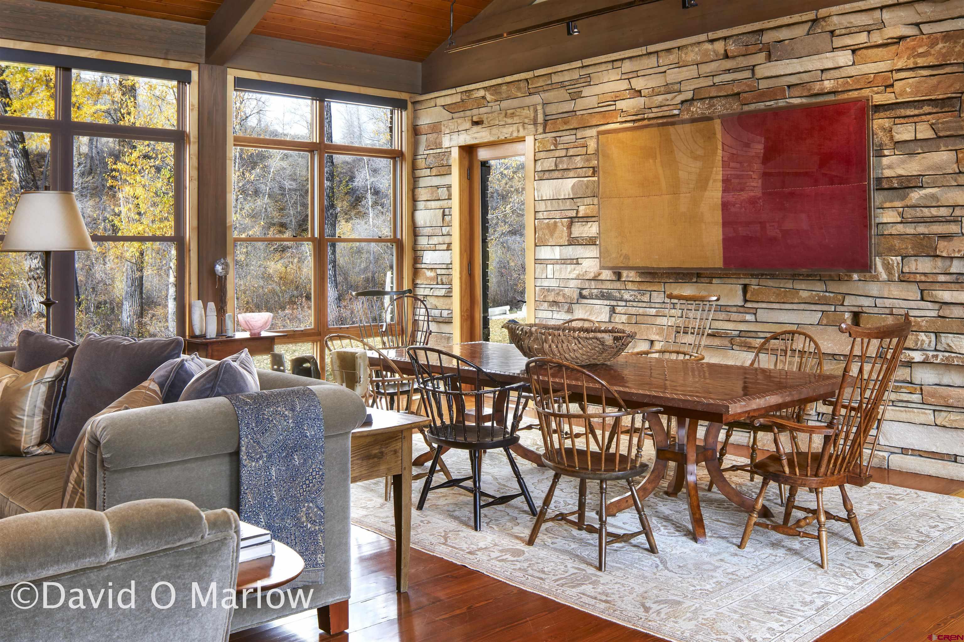 505 Eagle Creek Road Gunnison, CO 81230 - Photo 8 of 45 a dining room with furniture a chandelier and wooden floor