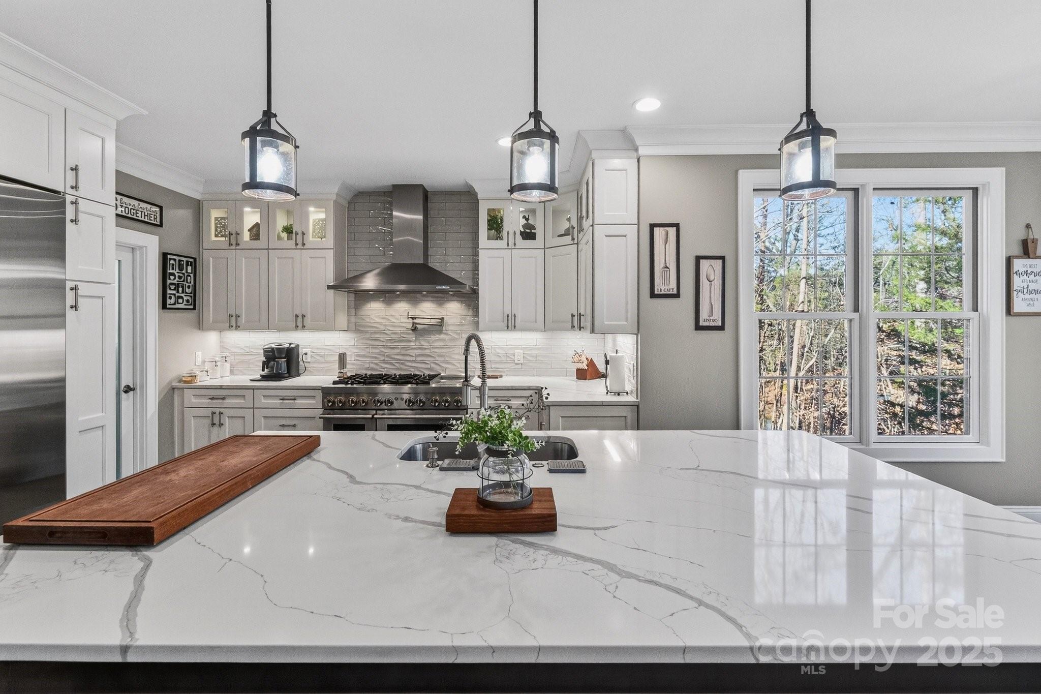 7653 Juniper Lane Denver, NC 28037 - Photo 12 of 43 a large kitchen with stainless steel appliances granite countertop a stove a refrigerator a oven and a chandelier