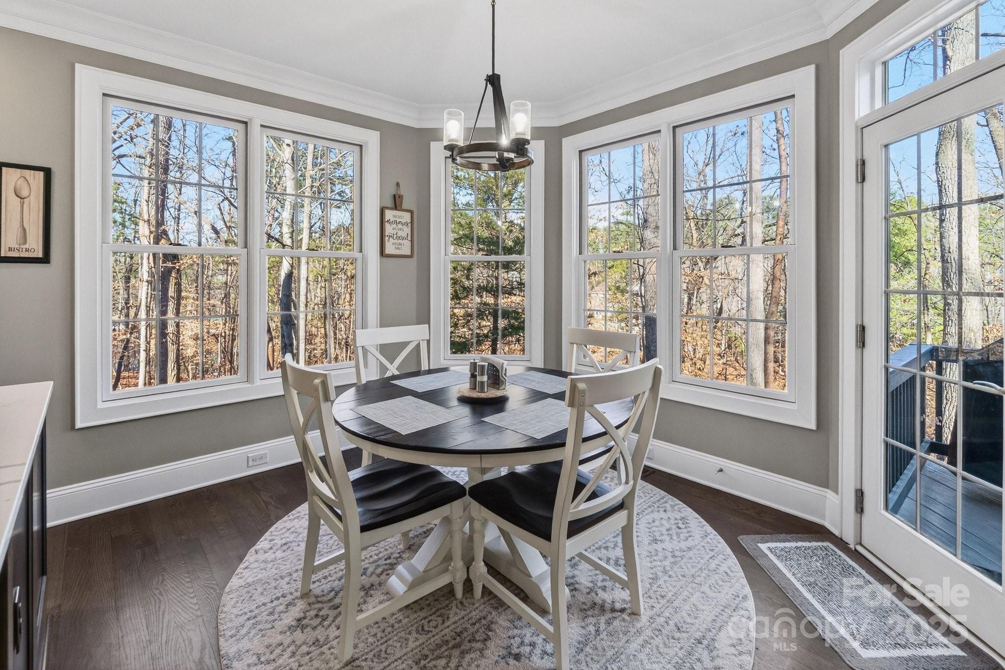 7653 Juniper Lane Denver, NC 28037 - Photo 15 of 43 a dining room with furniture large windows and wooden floor
