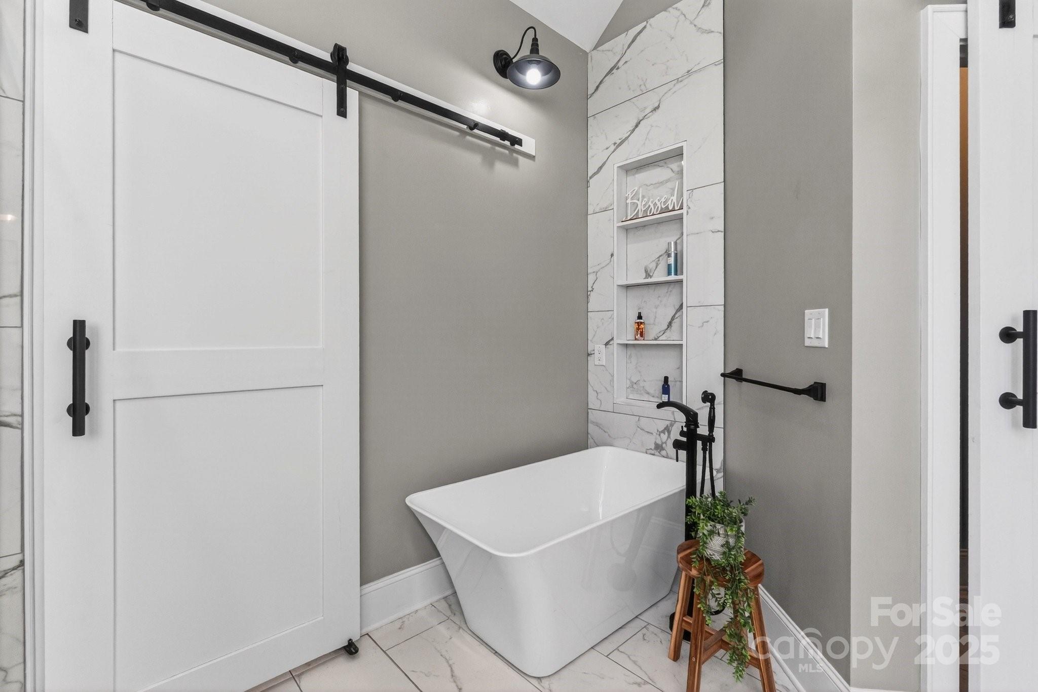 7653 Juniper Lane Denver, NC 28037 - Photo 23 of 43 a bath tub sitting next to a white sink and a shower