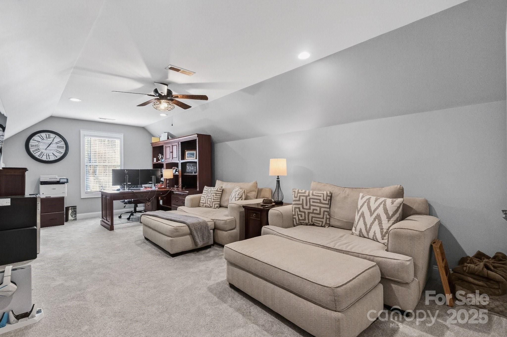 7653 Juniper Lane Denver, NC 28037 - Photo 25 of 43 a living room with furniture a clock and a window