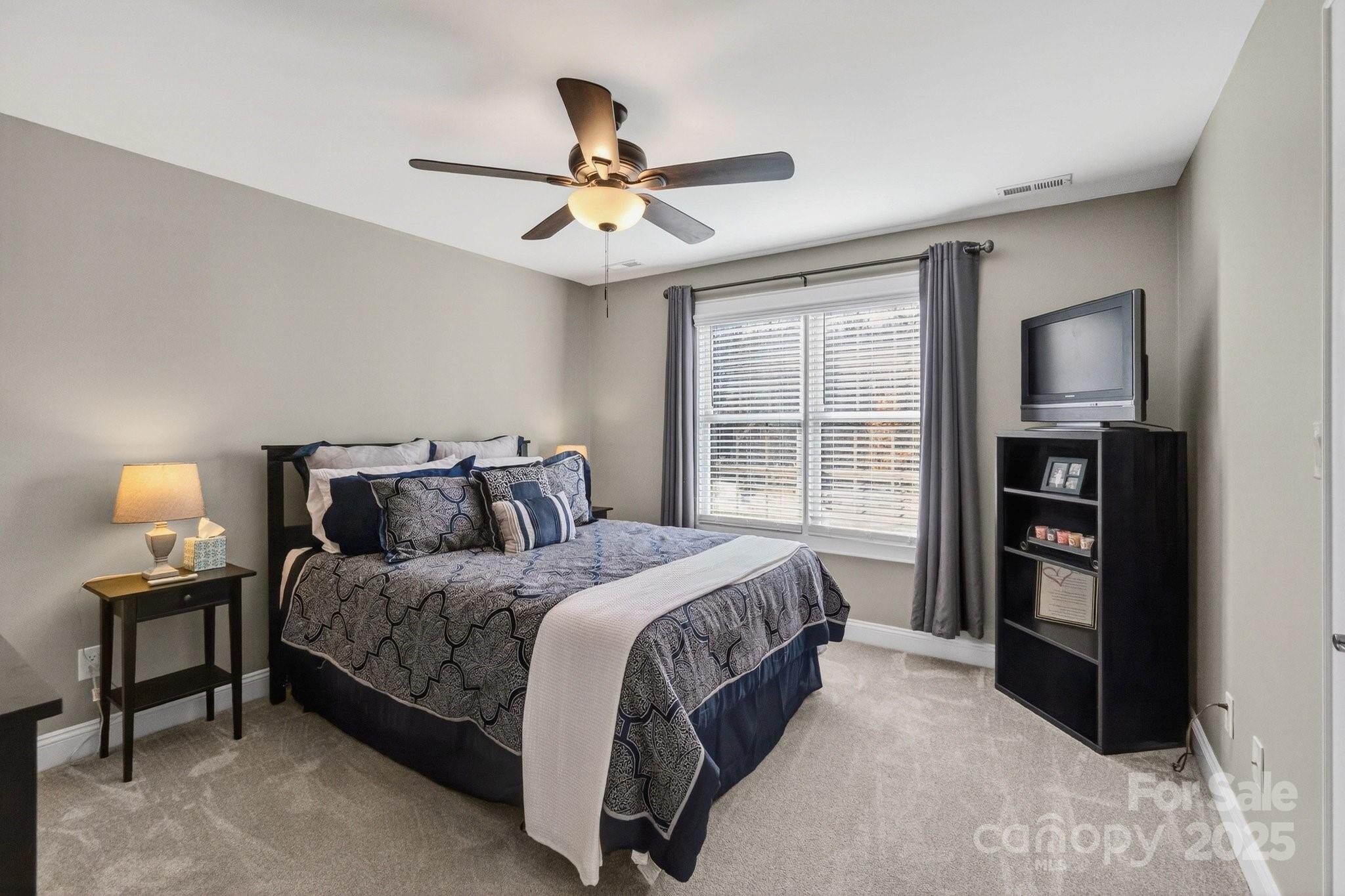 7653 Juniper Lane Denver, NC 28037 - Photo 30 of 43 a bedroom with a bed furniture and a window