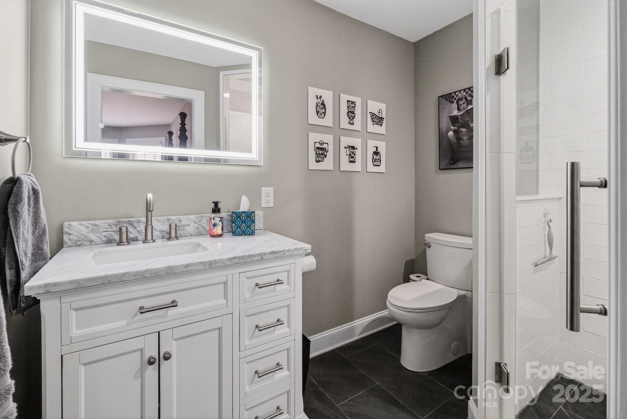 7653 Juniper Lane Denver, NC 28037 - Photo 31 of 43 a bathroom with a granite countertop toilet sink and mirror
