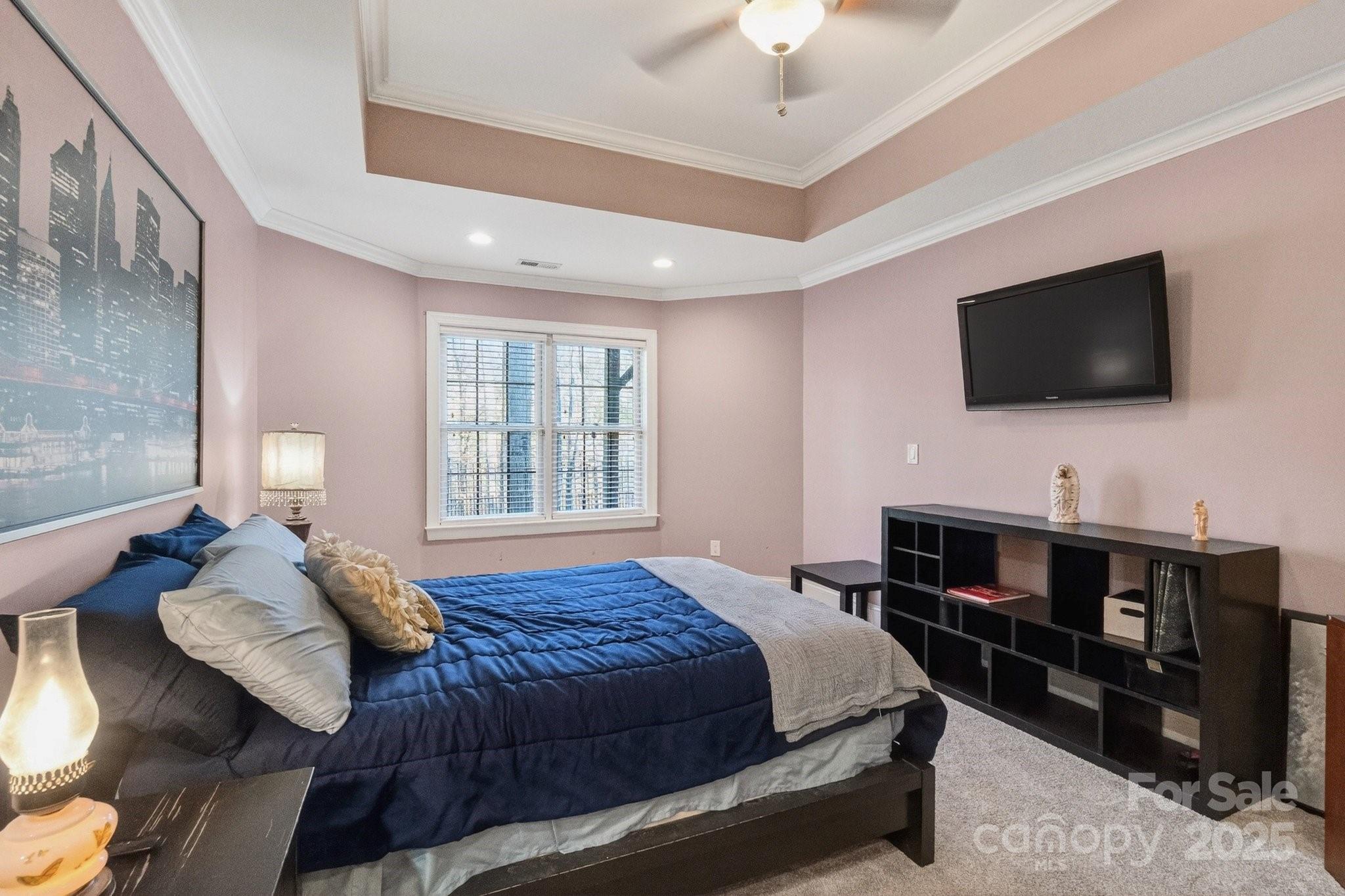 7653 Juniper Lane Denver, NC 28037 - Photo 36 of 43 a spacious bedroom with a bed and a flat screen tv