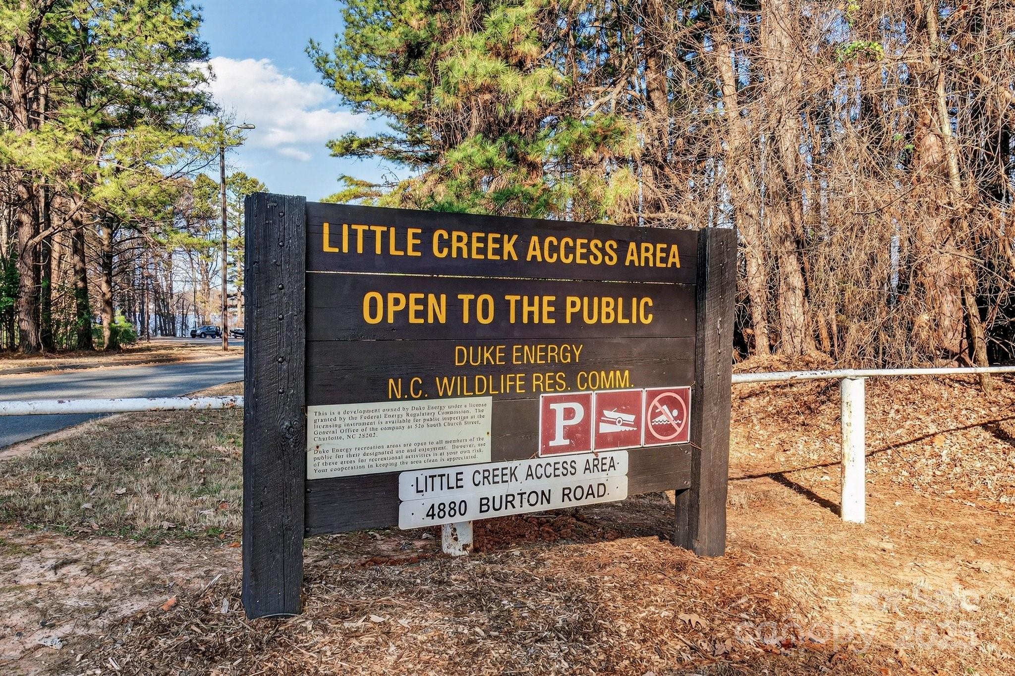 7653 Juniper Lane Denver, NC 28037 - Photo 40 of 43 a view of a street sign under a large tree