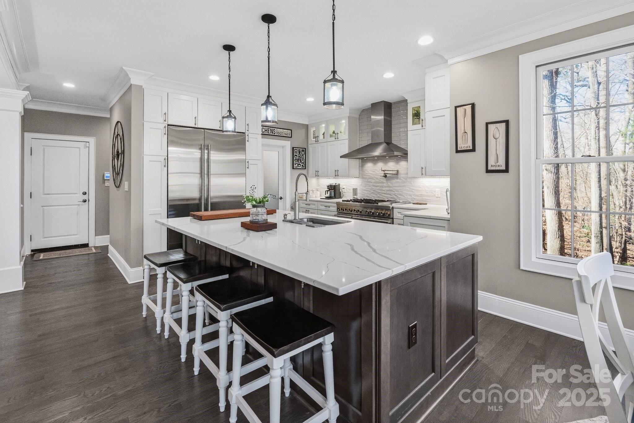 7653 Juniper Lane Denver, NC 28037 - Photo 10 of 43 a kitchen with stainless steel appliances kitchen island granite countertop a kitchen island hardwood floor and a sink