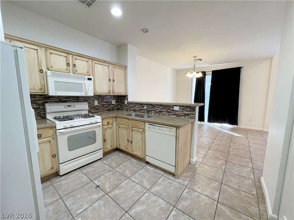 691 Principle Point Avenue Henderson, NV 89012 - Photo 8 of 30 A well-appointed kitchen features ample counter space and an inviting breakfast bar.