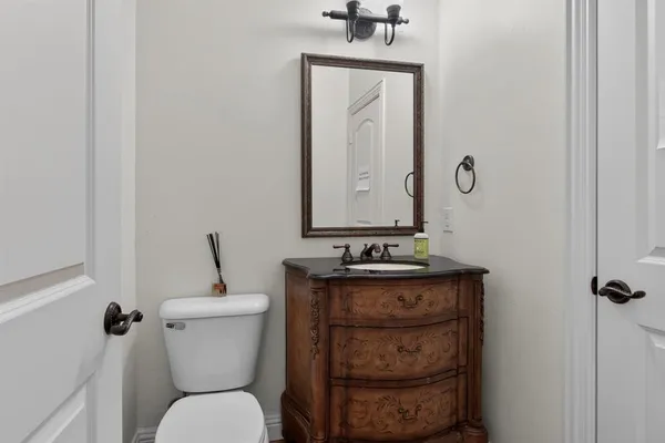 a bathroom with a toilet a sink and mirror