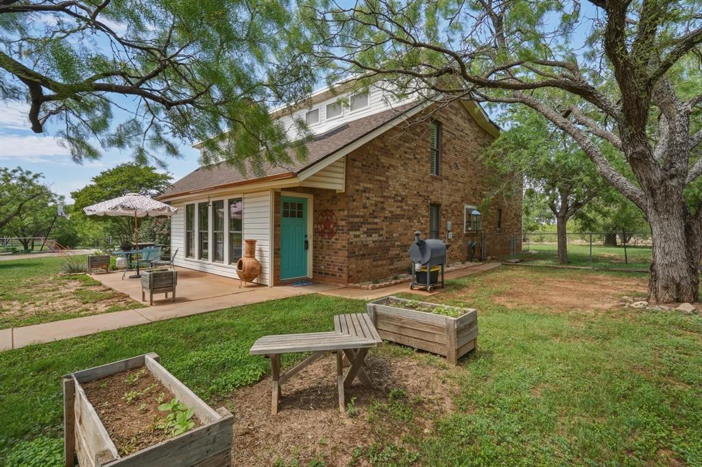 432 Clark Road Abilene, TX 79602 - Photo 1 of 40 a view of a house with backyard sitting area and garden