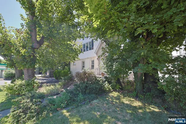 a backyard of a house with lots of green space and fountain