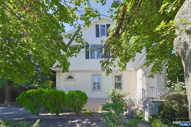 front view of a house with a tree