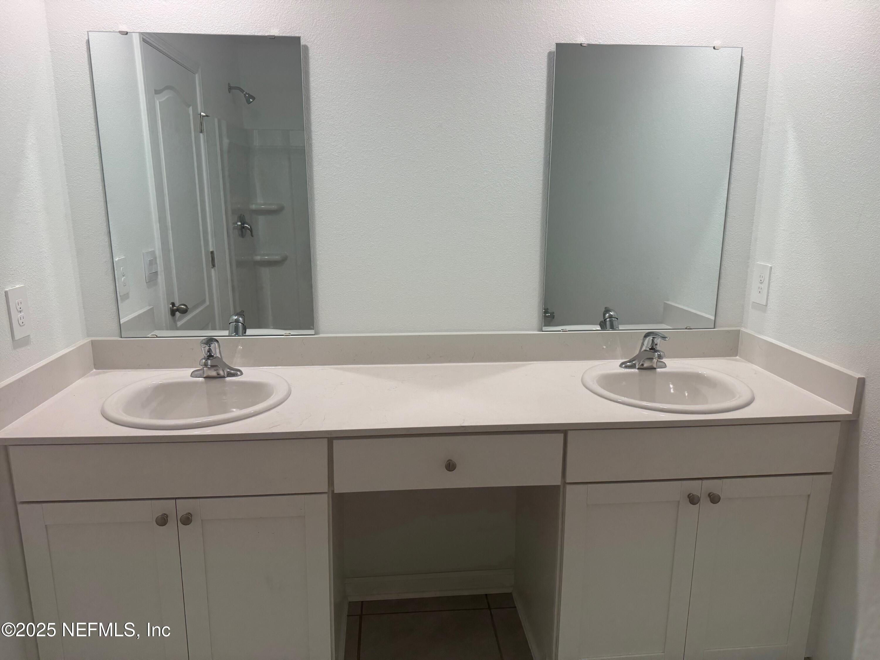 22 Blue Hvn Road St. Augustine, FL 32095 - Photo 18 of 59 a bathroom with a sink and a mirror