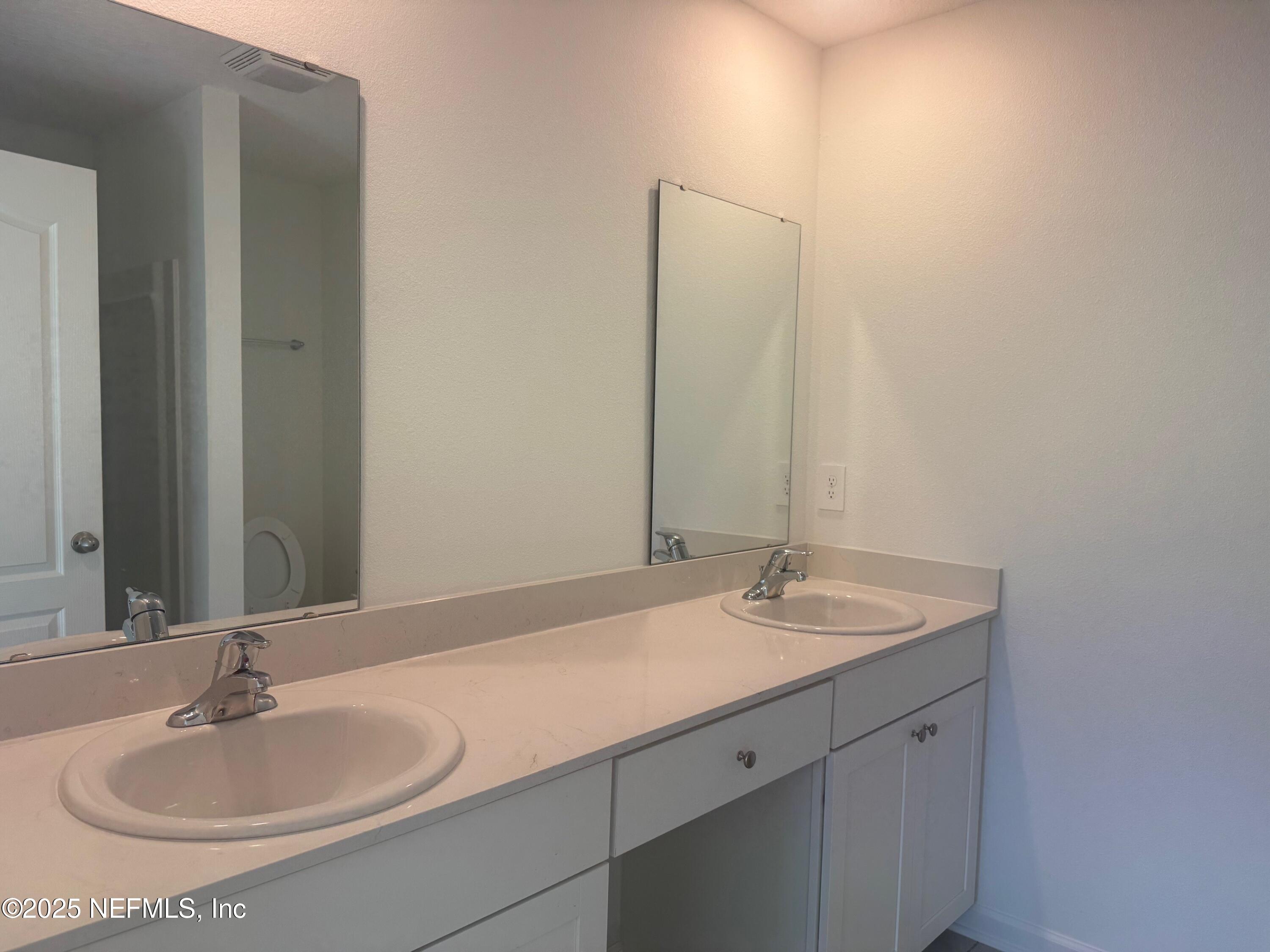 22 Blue Hvn Road St. Augustine, FL 32095 - Photo 19 of 59 a bathroom with a sink and a mirror