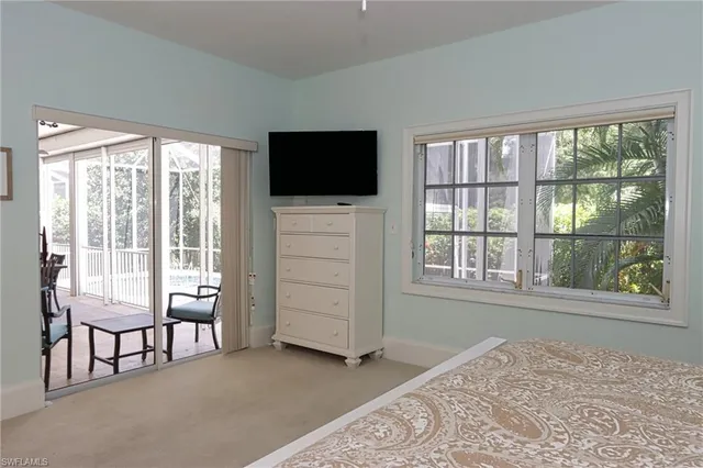 a bedroom with a bed and a television