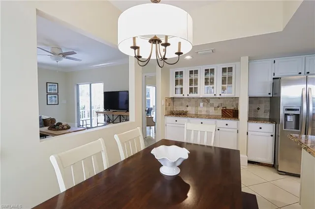 a kitchen with stainless steel appliances granite countertop a kitchen island a hardwood floor and a sink