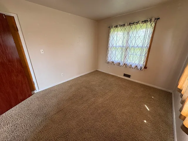 a view of an empty room and a window