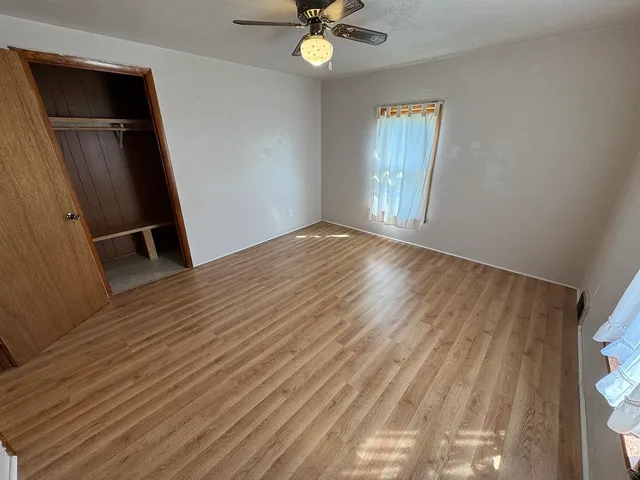 a white toilet sitting next to a bathroom sink and vanity