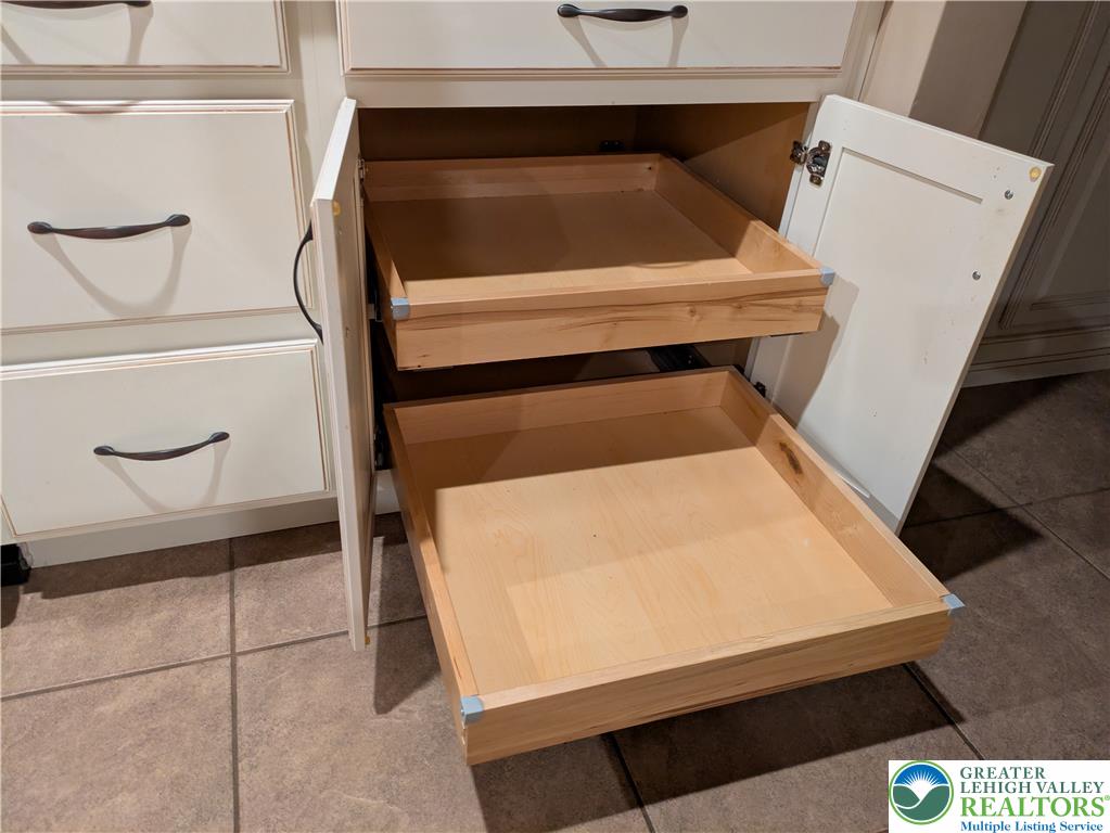 3285 Cherryville Road Northampton, PA 18067 - Photo 11 of 51 Custom pull-out wooden shelves maximize storage efficiency within the classic cabinetry.