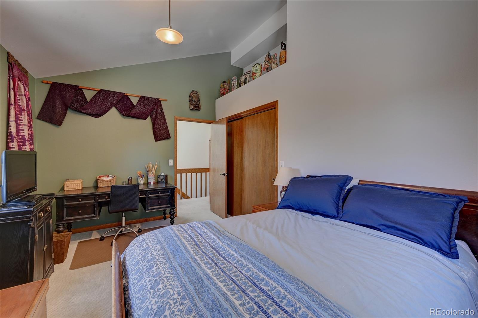 27 Conifer Road Golden, CO 80401 - Photo 21 of 40 a bedroom with a bed and dresser with chair