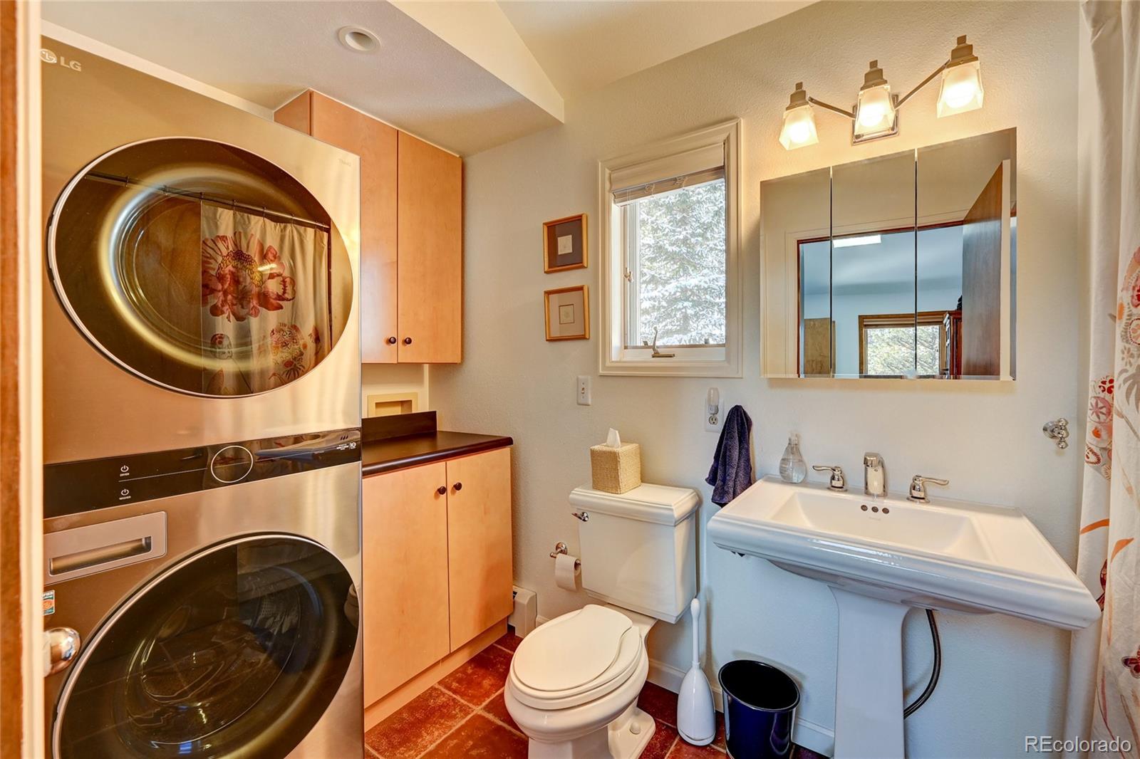 27 Conifer Road Golden, CO 80401 - Photo 24 of 40 a bathroom with a toilet a sink and a mirror